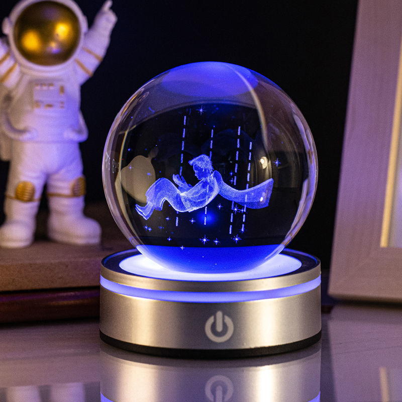 Sélection de cadeaux pour la maison : petite lampe de nuit colorée avec une boule de cristal lumineuse en 3D gravée à l'intérieur.